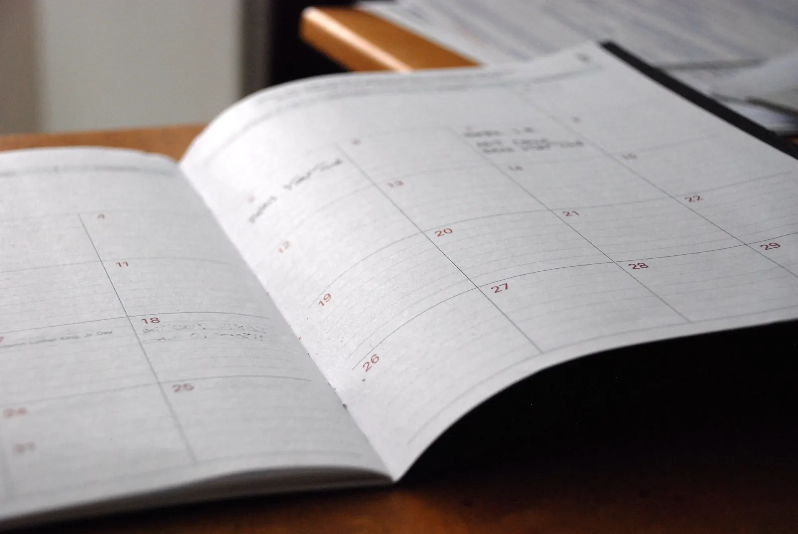 An open monthly planner showing a calendar