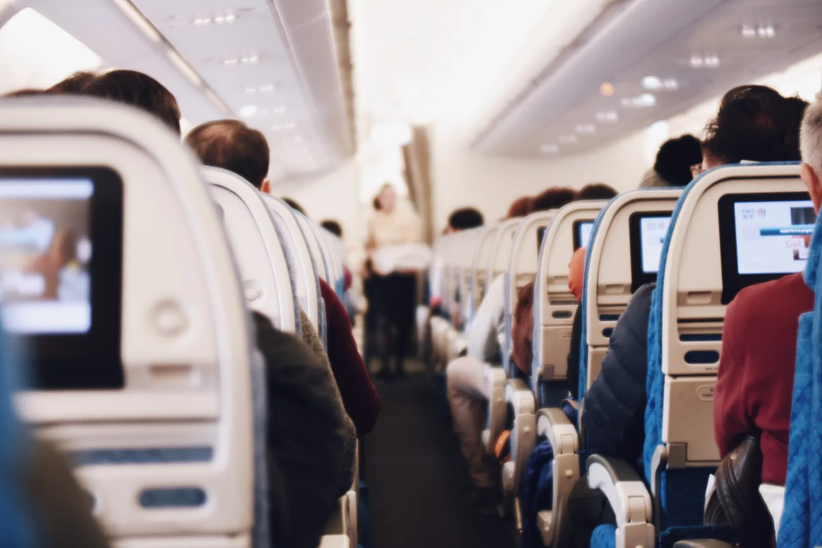 Rows of passenger seats along the aisle of an airliner cabin