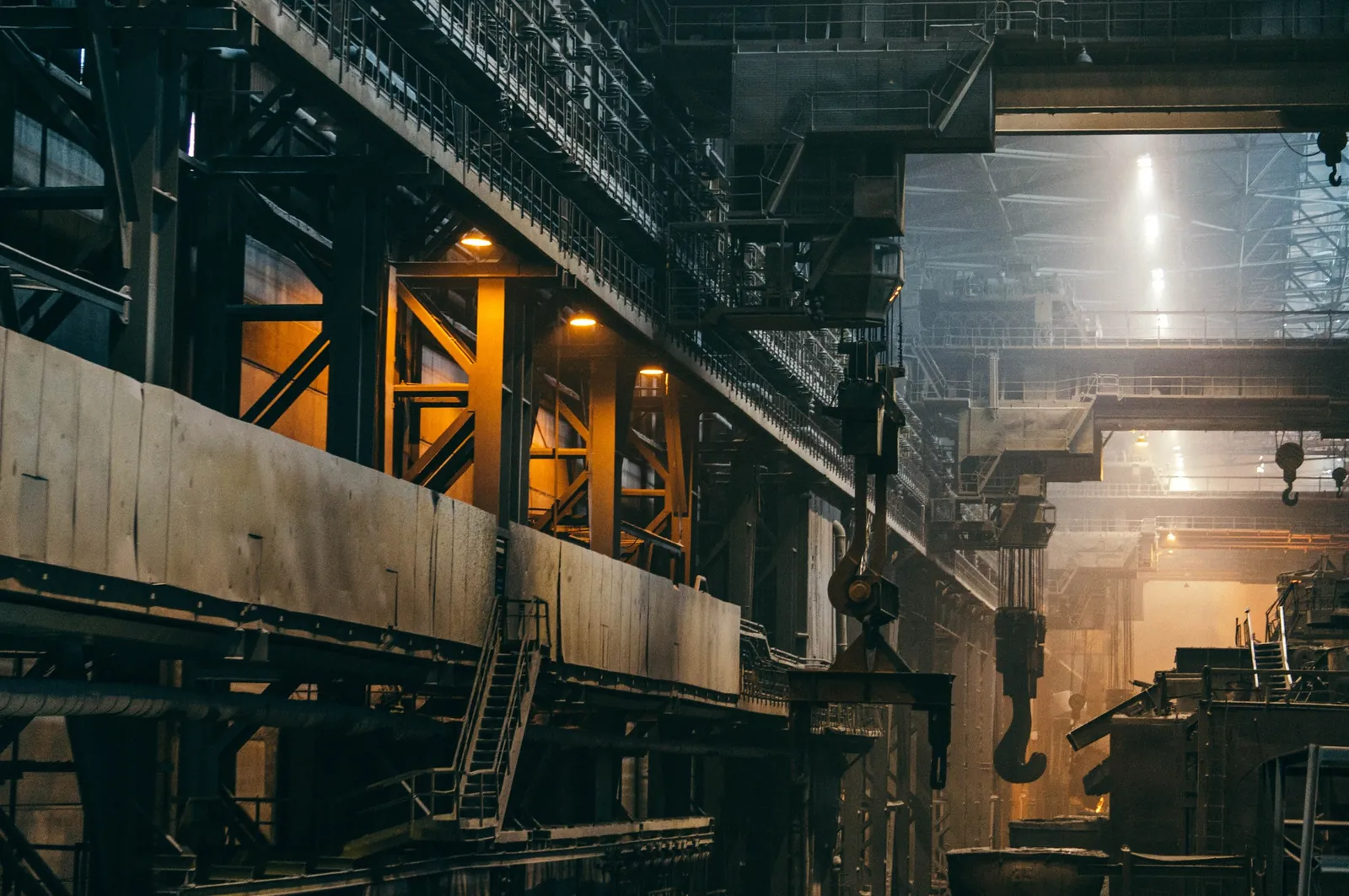 The inside of a large industrial hall with overhead cranes